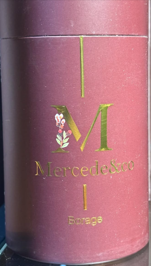 Scatola cilindrica in metallo rosa per tisana alla borragine MercedesTea, confezione elegante artigianale